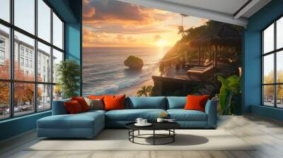 A cinematic view of the sunset over an ocean cliff, overlooking the water and beach in Bali with luxury villas Wall mural