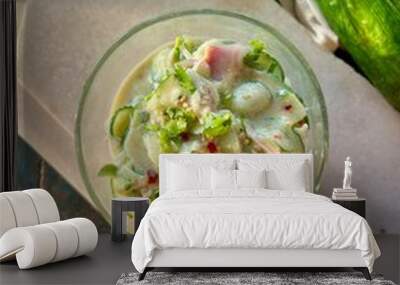 Top Angle shot of Delicious cucumber salad in a glass bowl on table, closeup.  Wall mural