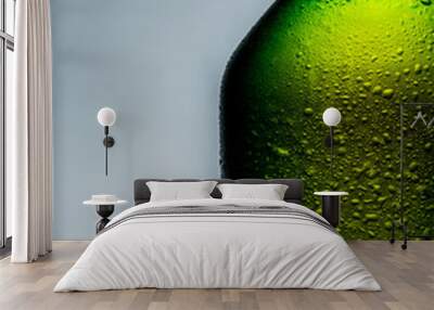 A cold green beer bottle with water drops Wall mural