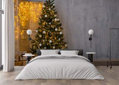 christmas and new year evening background - christmas tree, heap of gifts, folding screen with light Wall mural