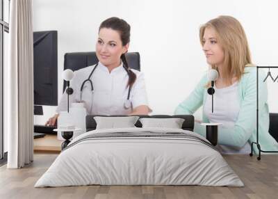 female doctor explaining results to young patient in office Wall mural