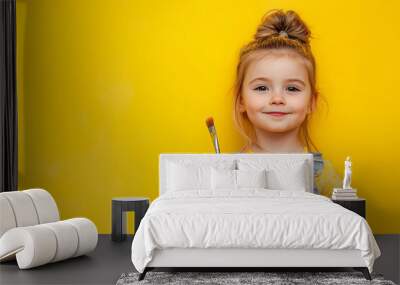 little cute girl with paint brush on yellow Wall mural