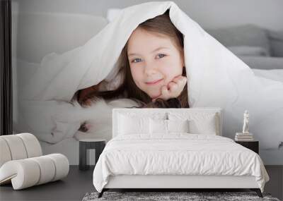 little preschool girl with her cute dog on the bed Wall mural