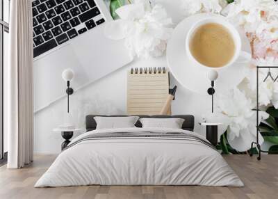 Top view of coffee cup, notebook, pen, laptop and pionies Wall mural