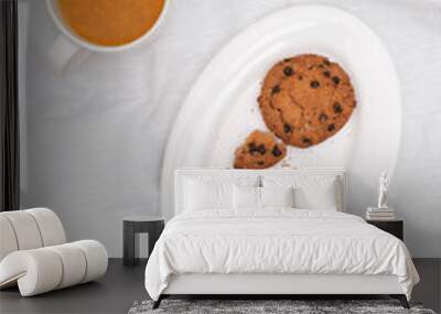 Vitaminic healthy sea buckthorn tea with biscuits on white plate on white background, selective focus, copy space Wall mural