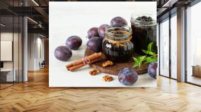 Jar with homemade plums jam and fresh fruits on a table Wall mural