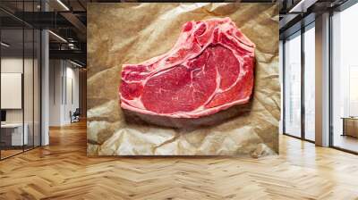 Fresh, huge and appetizing club steak on brown paper Wall mural