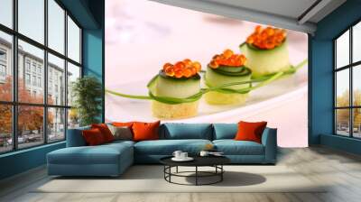 Red caviar on fresh cucumber as snack Wall mural