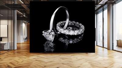 Interwoven solitaire diamond engagement ring, eternity wedding band on black background Wall mural