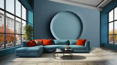 Vibrant blue plate displayed on neutral gray wall Wall mural