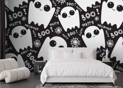 Seamless pattern with cute little cartoon ghosts on black background. Halloween boo funny symbols flying above the ground. Vector hand-drawn illustration.  Wall mural