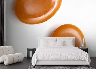 close up of two caramel candies on white background Wall mural