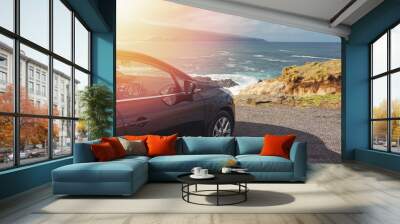 Car standing near the ocean with beautiful view on sunny day. Wall mural