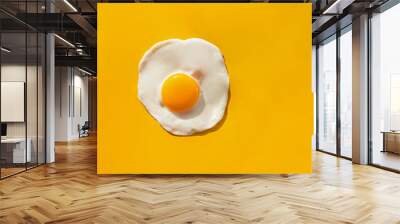 Fried egg on yellow background Wall mural