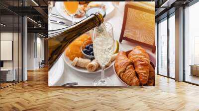 Pouring prosecco or champagne into a glass close-up. Wall mural