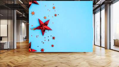 Red Christmas stars and snowflakes on blue background. Wall mural