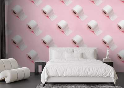 Rolls of white toilet paper on pink background. Wall mural