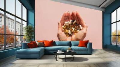 Woman's hands holding a lot of different pills or dietic supplements Wall mural