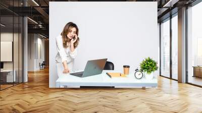 Beautiful successful woman talking on phone at the modern office Wall mural