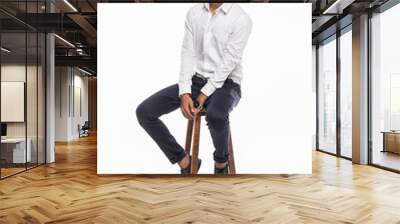 Young Indian man sitting on chair and possing isolated for white background Wall mural