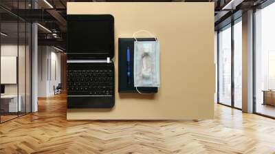 Laptop, disposable face mask, antiseptic and notebook with pen. Concept of working in office in compliance with the rules of personal protection and social distance or working from home. Remote work Wall mural