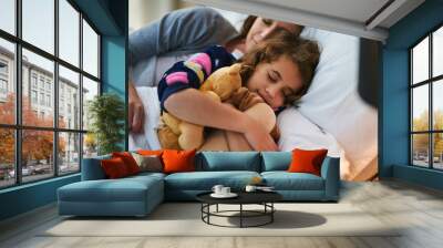 Safe and snug. Cropped shot of a mother and daughter sleeping together in bed. Wall mural