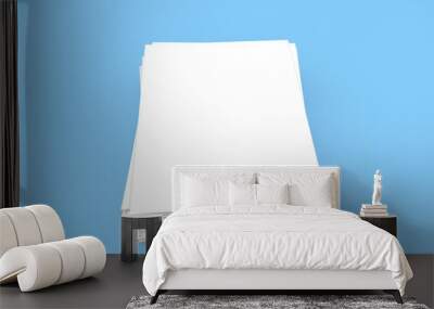 Stack of white sheets of A4 office paper on a light blue background. Wall mural