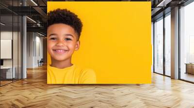 Black power haired African American boy against a yellow background. Wall mural