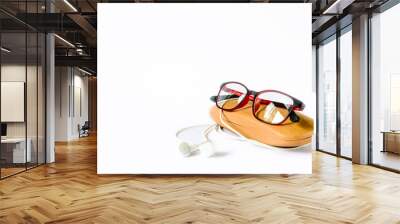 eyeglass placed on its wooden case Wall mural