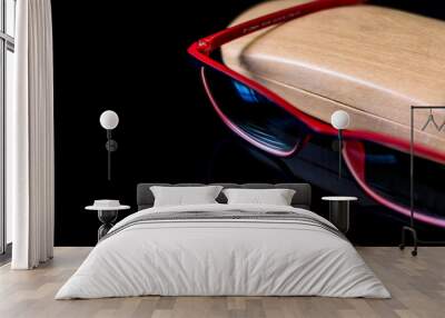 eyeglass with wooden case on top of reflective surface Wall mural