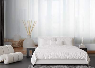 Burning candles, white towel and aroma sticks on table with blurry window curtain background Wall mural