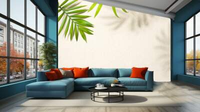 Sandy beach background top view with tropical leaves and shadows Wall mural