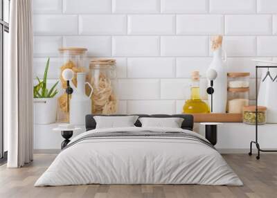 Wooden pedestal on table in kitchen interior with food ingredients Wall mural