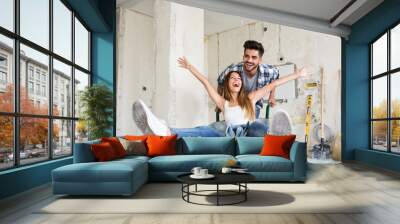 Loving couple is having fun while renovating their home Wall mural