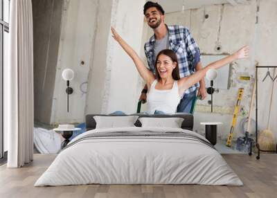 Loving couple is having fun while they are renovating house Wall mural