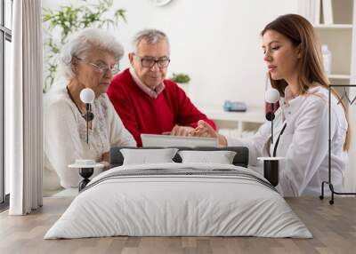 senior couple on consultation with a doctor Wall mural