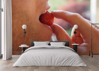 Man eating strawberry Wall mural