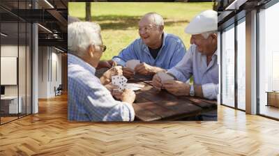 active seniors, group of old friends playing cards at park Wall mural