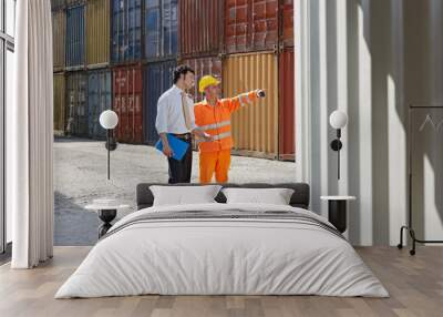 businessman and manual worker with cargo containers Wall mural