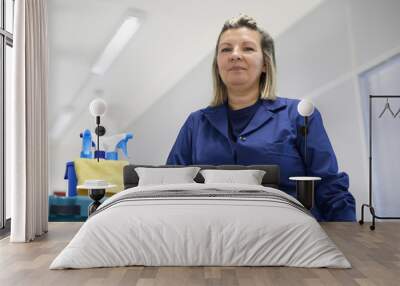 portrait of happy professional female cleaner smiling in office Wall mural