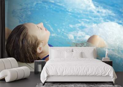 Portrait of young woman sitting in swimming pool Wall mural