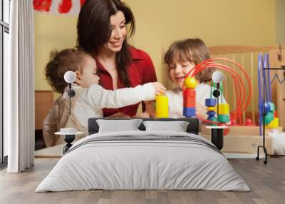 two little girls and female teacher in kindergarten Wall mural