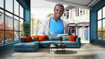 young african man smiling in library Wall mural