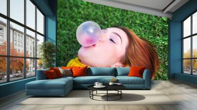 Young Woman Chewing Gum And Making Big Balloon Wall mural