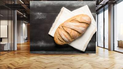 loaf of bread on table, perfect bread to accompany your healthy meals on a brown wooden table with part covered in flour Wall mural