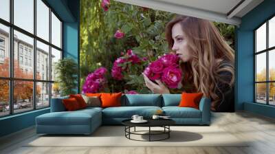 beautiful young woman with auburn hair and green eyes admiring r Wall mural