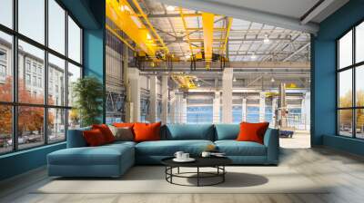 Concrete floor inside factory or warehouse building with empty space for industry background. Overhead crane or bridge crane include hoist lifting for transportation, manufacturing, and production. Wall mural