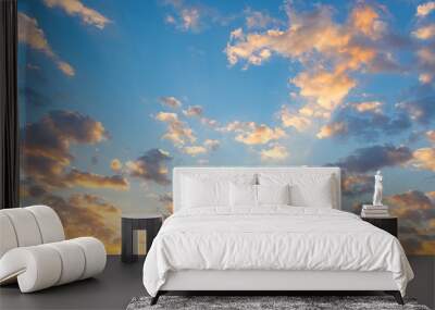 Dramatic sky background include sunset or sunrise, abstract cloud look fluffy. Represent weather, wind, heaven, freedom and god. Colorful with yellow, orange and blue color at evening in autumn.  Wall mural