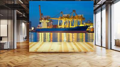 Gantry crane loading and unloading cargo container  from cargo ship at port to show global international logistics and transportation by cargo ship and cargo container, Logistic import export concept. Wall mural