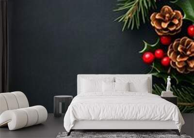 Festive Christmas ornaments and pine branches arranged on a dark background. Wall mural